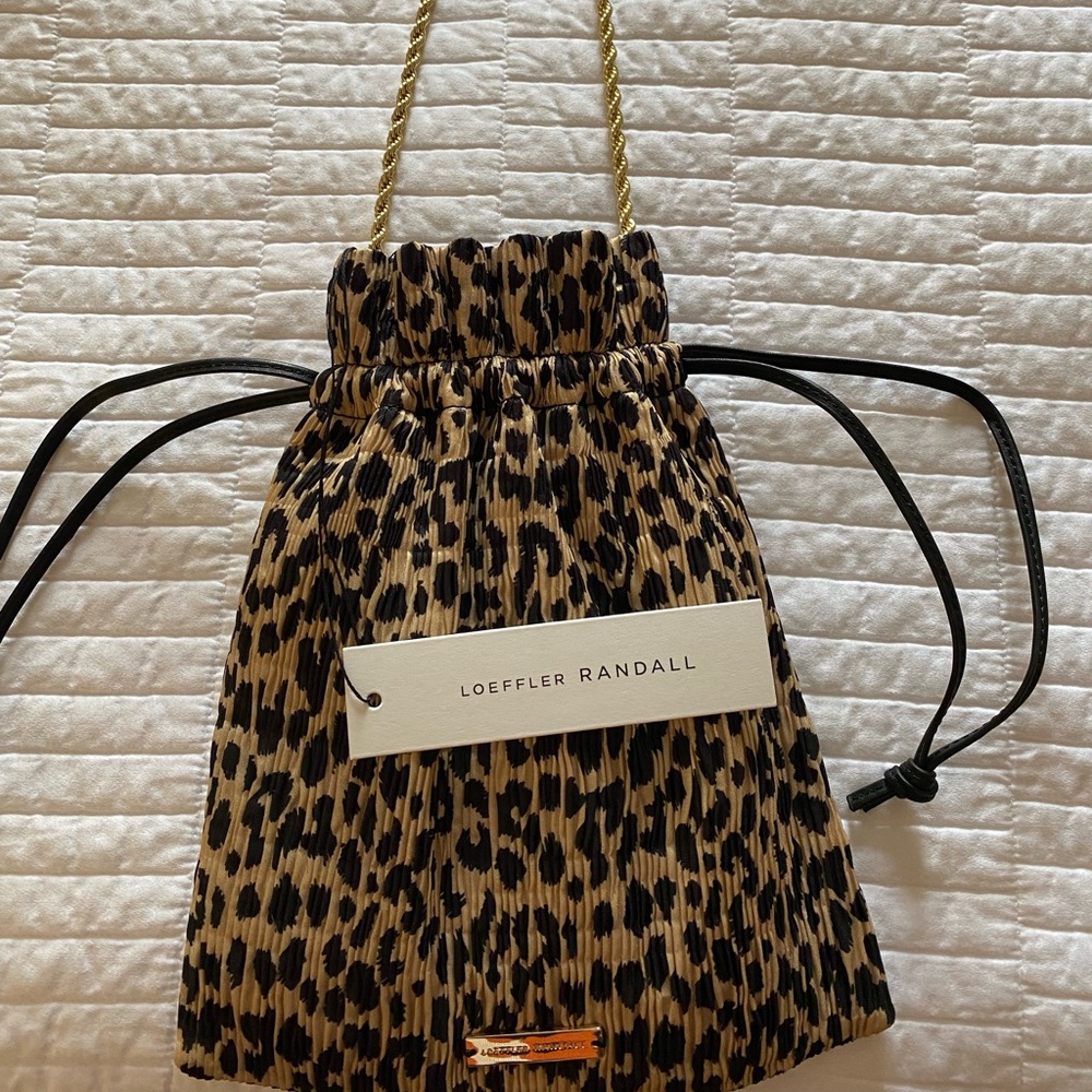 Draw string with gold chain handle. Can be worn without the gold chain